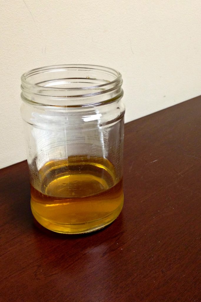 Glass of apple cider vinegar and dish soap
